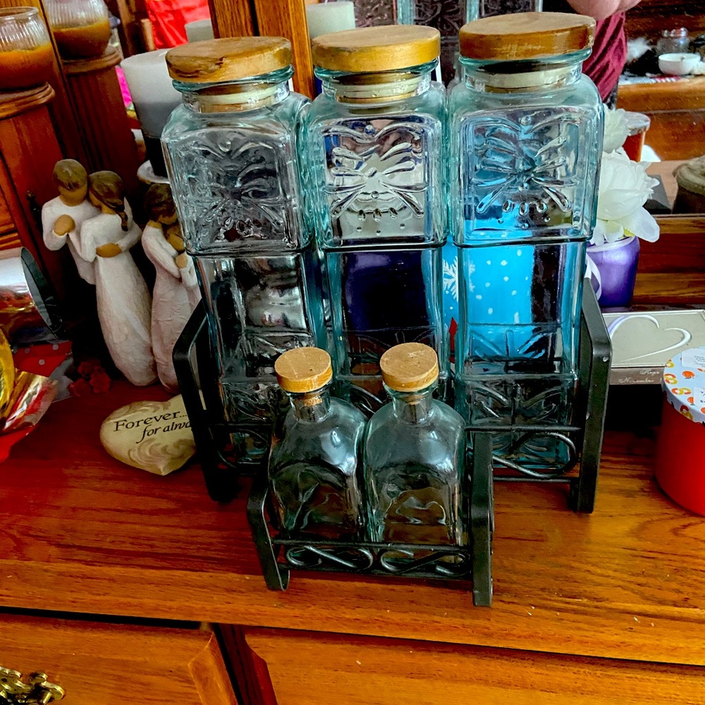Pasta and oil and vinegar jars.  Five jars in black metal stand.